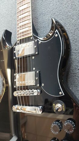 EKO SG-model in zwart, nu met riem, dvd, plectrums, kabel en extra set snaren